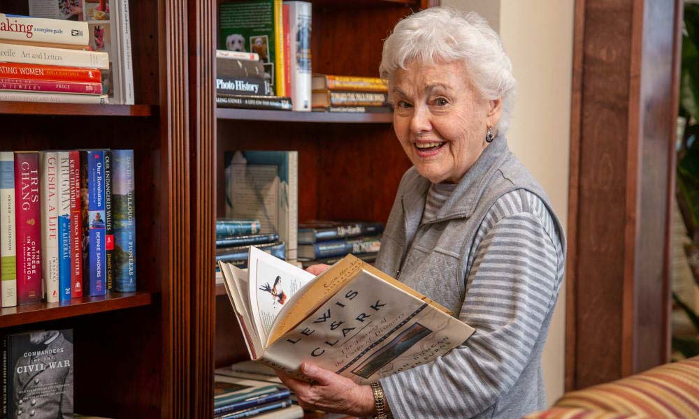 Independent senior in Albuquerque selecting a book