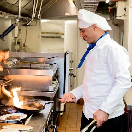 The Rio Grande Chef Created Meals, chef frying a dish.