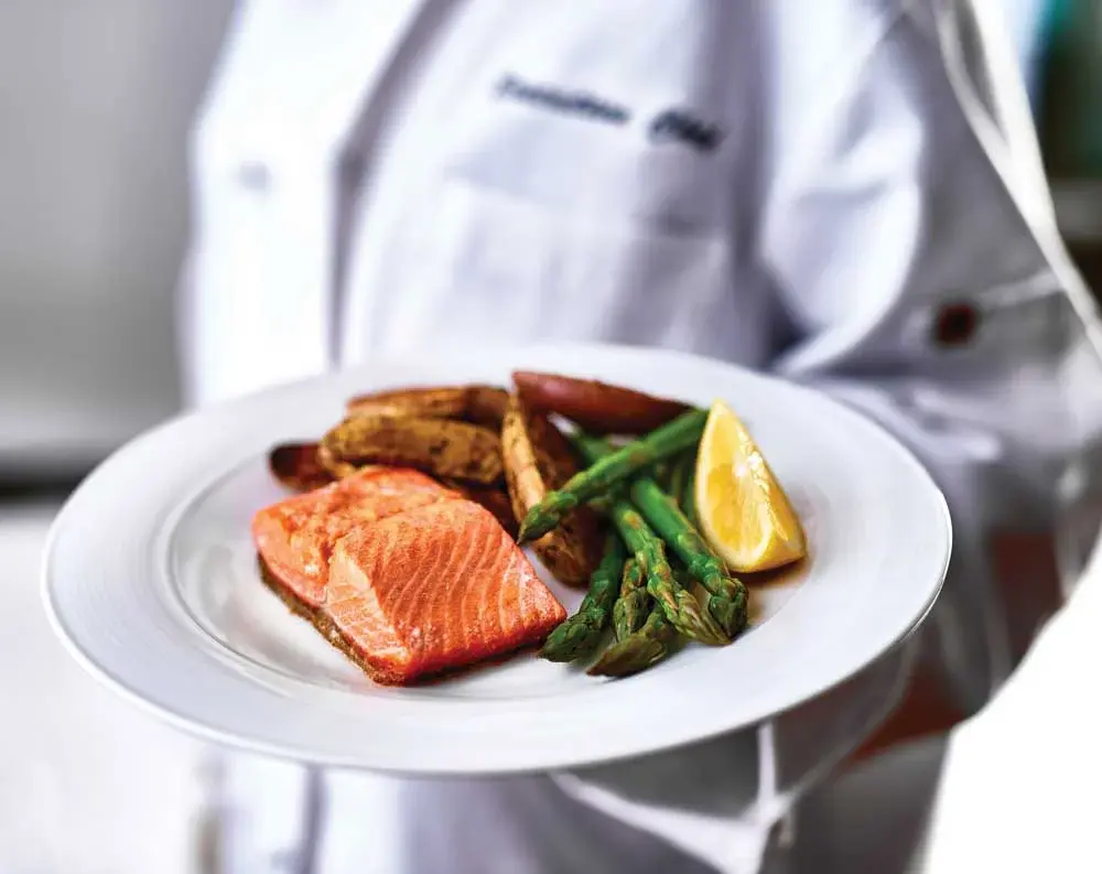 The Rio Grande Chef Created Meals, chef delivering a finished dish.
